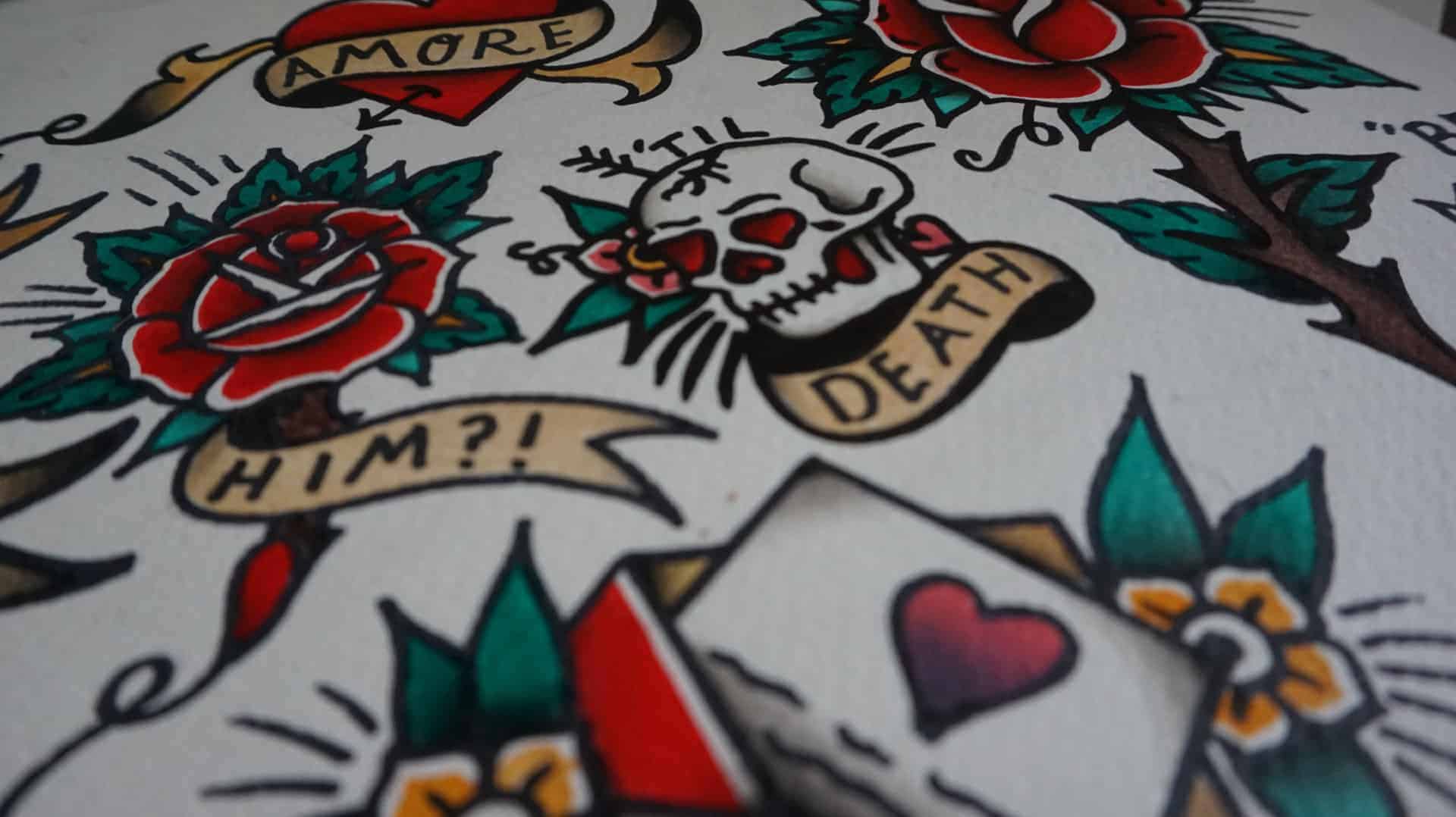 Tattoo flash designs with a skull, playing cards and some rosesa